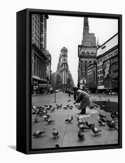 Man Feeding Pigeons in an Empty Times Square During a Taxi Strike-Yale Joel-Framed Premier Image Canvas