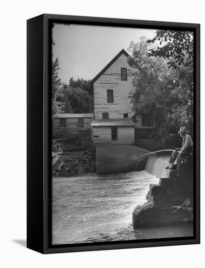 Man Fishing Beside a Waterfall and a 100 Year Old Mill-Bob Landry-Framed Premier Image Canvas