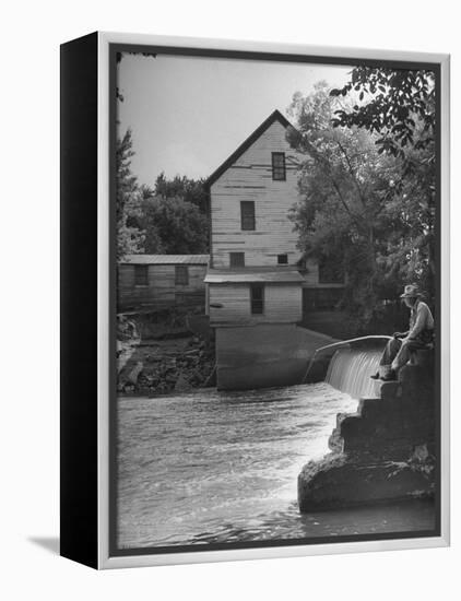 Man Fishing Beside a Waterfall and a 100 Year Old Mill-Bob Landry-Framed Premier Image Canvas