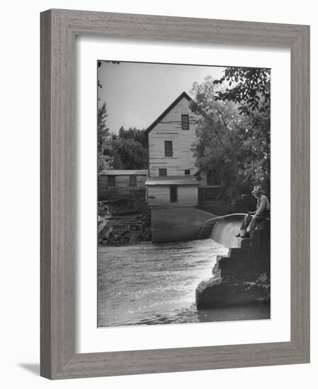 Man Fishing Beside a Waterfall and a 100 Year Old Mill-Bob Landry-Framed Photographic Print