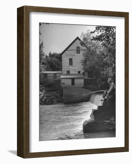 Man Fishing Beside a Waterfall and a 100 Year Old Mill-Bob Landry-Framed Photographic Print