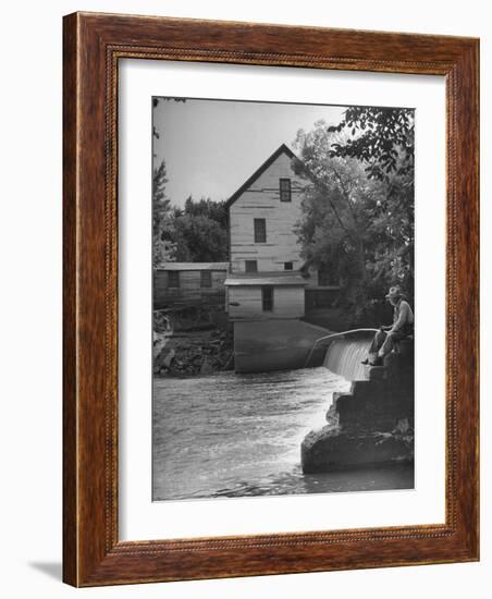 Man Fishing Beside a Waterfall and a 100 Year Old Mill-Bob Landry-Framed Photographic Print