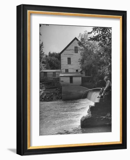 Man Fishing Beside a Waterfall and a 100 Year Old Mill-Bob Landry-Framed Photographic Print