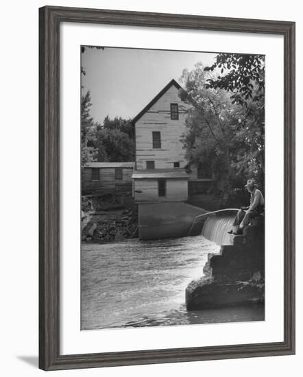 Man Fishing Beside a Waterfall and a 100 Year Old Mill-Bob Landry-Framed Photographic Print