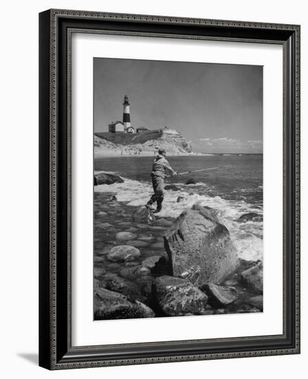 Man Fishing Off Montauk Point. Montauk Lighthouse Visible in Background-Alfred Eisenstaedt-Framed Photographic Print