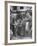 Man Fixing Basket on Bicycle as Children Watch Attentively-Nina Leen-Framed Photographic Print