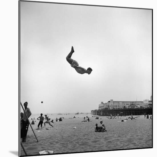 Man Flying Off a Trampoline at Santa Monica Beach-Loomis Dean-Mounted Photographic Print