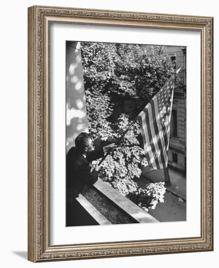 Man Hanging the American Flag Out of the Osteopath's Office Window During WWII-George Strock-Framed Photographic Print