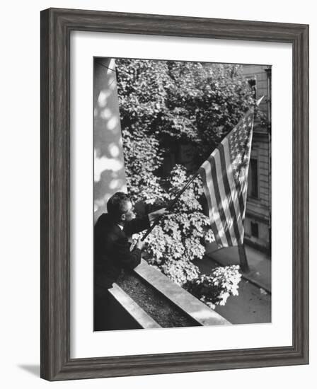 Man Hanging the American Flag Out of the Osteopath's Office Window During WWII-George Strock-Framed Photographic Print