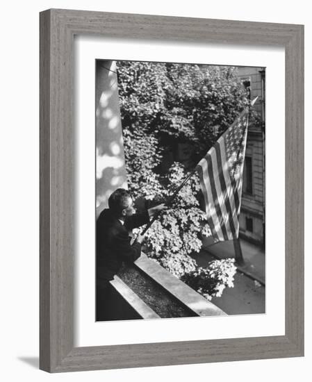 Man Hanging the American Flag Out of the Osteopath's Office Window During WWII-George Strock-Framed Photographic Print