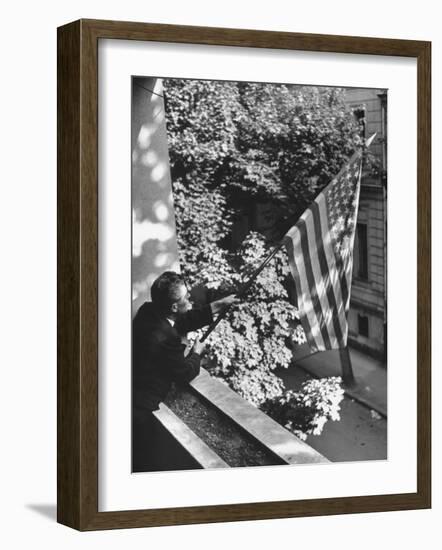 Man Hanging the American Flag Out of the Osteopath's Office Window During WWII-George Strock-Framed Photographic Print