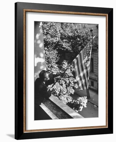 Man Hanging the American Flag Out of the Osteopath's Office Window During WWII-George Strock-Framed Photographic Print