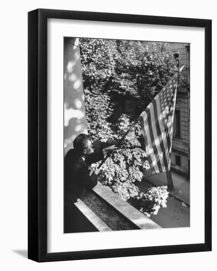 Man Hanging the American Flag Out of the Osteopath's Office Window During WWII-George Strock-Framed Photographic Print