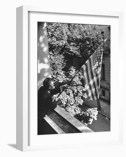 Man Hanging the American Flag Out of the Osteopath's Office Window During WWII-George Strock-Framed Photographic Print