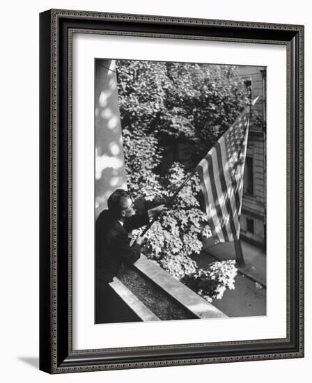 Man Hanging the American Flag Out of the Osteopath's Office Window During WWII-George Strock-Framed Photographic Print