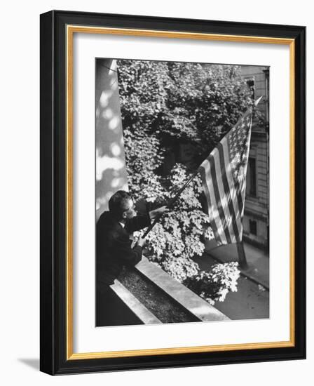 Man Hanging the American Flag Out of the Osteopath's Office Window During WWII-George Strock-Framed Photographic Print