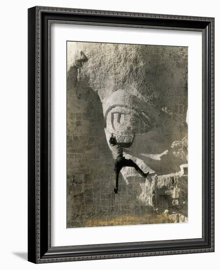 Man Hangs Onto Eye at Mount Rushmore-null-Framed Photographic Print