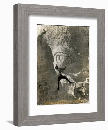 Man Hangs Onto Eye at Mount Rushmore-null-Framed Photographic Print