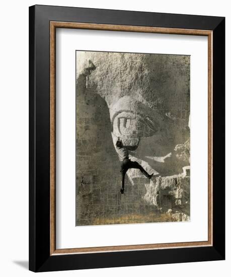 Man Hangs Onto Eye at Mount Rushmore-null-Framed Photographic Print