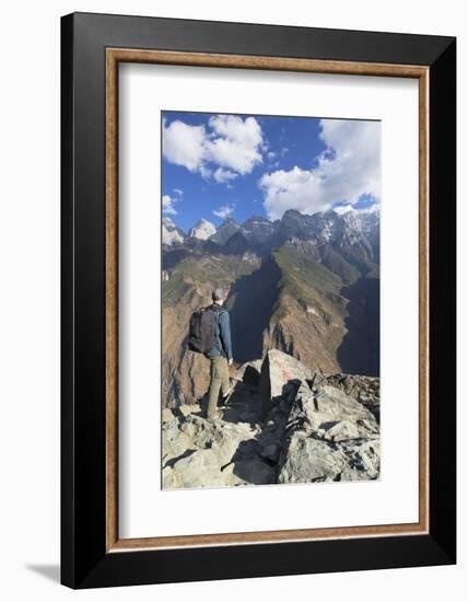 Man hiking in Tiger Leaping Gorge, UNESCO World Heritage Site, with Jade Dragon Snow Mountain (Yulo-Ian Trower-Framed Photographic Print