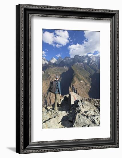 Man hiking in Tiger Leaping Gorge, UNESCO World Heritage Site, with Jade Dragon Snow Mountain (Yulo-Ian Trower-Framed Photographic Print