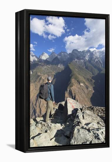 Man hiking in Tiger Leaping Gorge, UNESCO World Heritage Site, with Jade Dragon Snow Mountain (Yulo-Ian Trower-Framed Premier Image Canvas