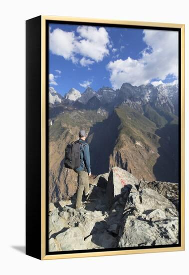 Man hiking in Tiger Leaping Gorge, UNESCO World Heritage Site, with Jade Dragon Snow Mountain (Yulo-Ian Trower-Framed Premier Image Canvas