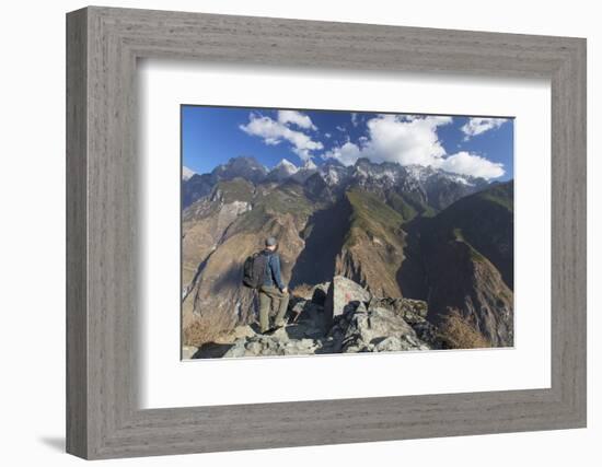 Man hiking in Tiger Leaping Gorge, UNESCO World Heritage Site, with Jade Dragon Snow Mountain (Yulo-Ian Trower-Framed Photographic Print