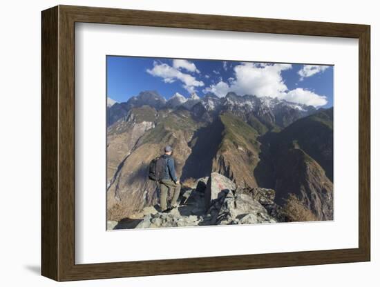 Man hiking in Tiger Leaping Gorge, UNESCO World Heritage Site, with Jade Dragon Snow Mountain (Yulo-Ian Trower-Framed Photographic Print