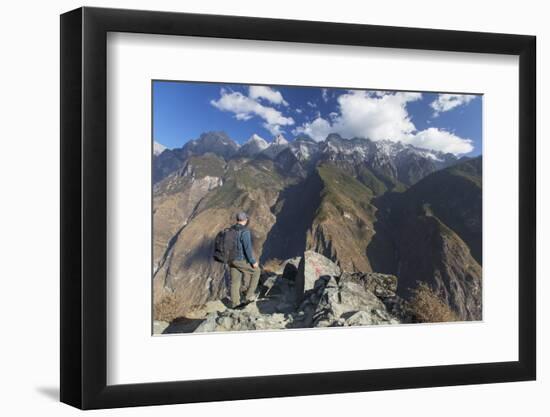 Man hiking in Tiger Leaping Gorge, UNESCO World Heritage Site, with Jade Dragon Snow Mountain (Yulo-Ian Trower-Framed Photographic Print