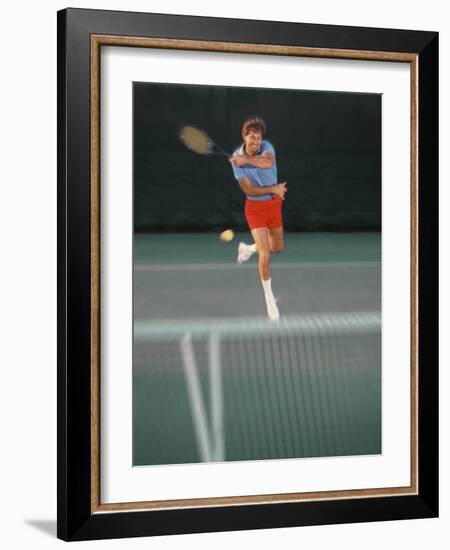 Man Hitting Tennis Ball-Bill Bachmann-Framed Photographic Print