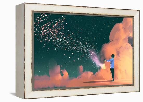 man holding a cage with floating star dust-Tithi Luadthong-Framed Stretched Canvas