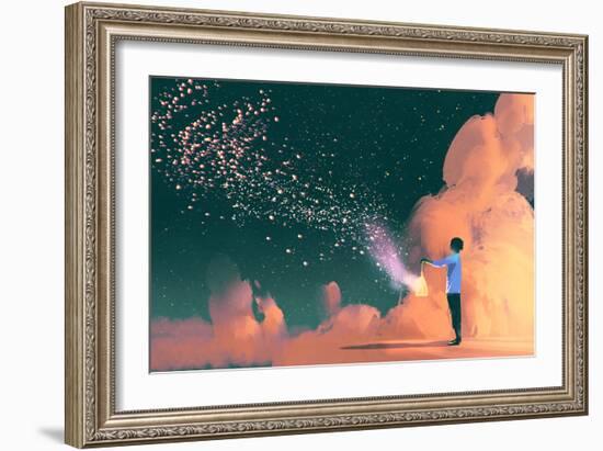 man holding a cage with floating star dust-Tithi Luadthong-Framed Art Print