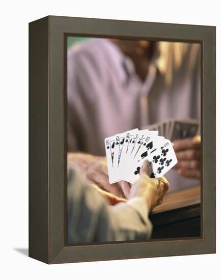 Man Holding Playing Cards-null-Framed Premier Image Canvas