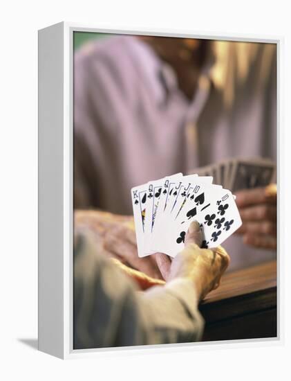 Man Holding Playing Cards-null-Framed Premier Image Canvas