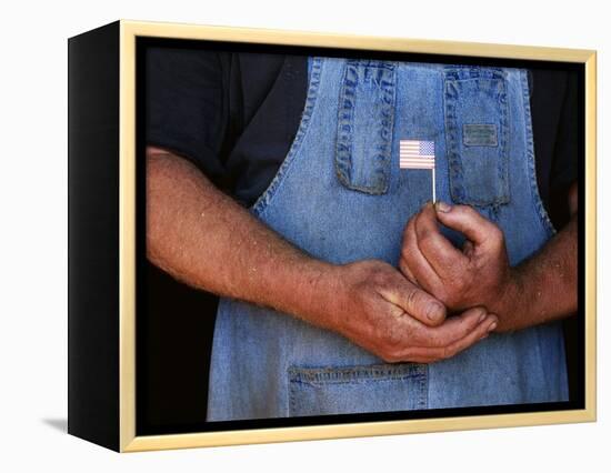 Man Holding Small American Flag-Bob Rowan-Framed Premier Image Canvas
