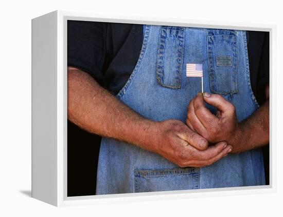 Man Holding Small American Flag-Bob Rowan-Framed Premier Image Canvas