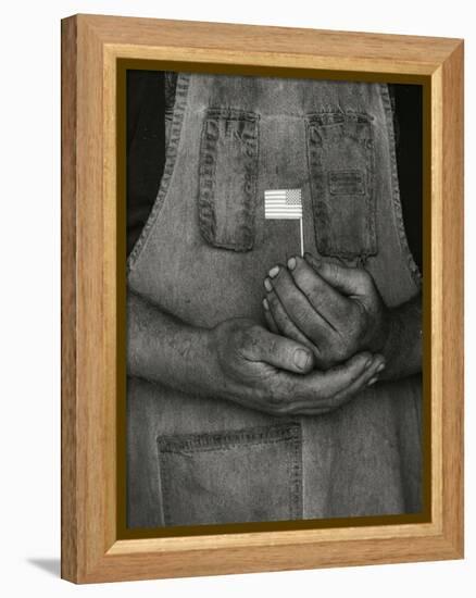 Man Holding Small American Flag-Bob Rowan-Framed Premier Image Canvas