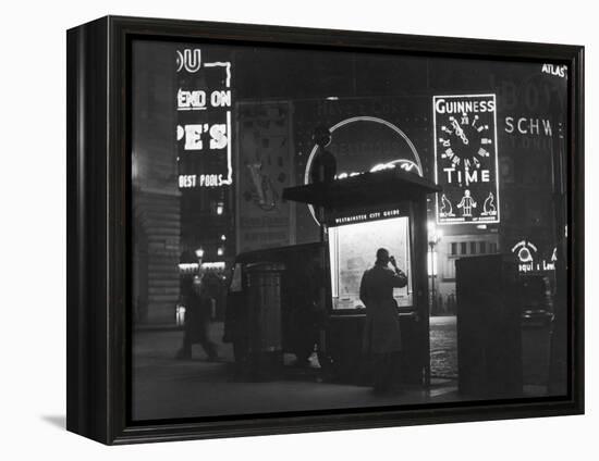 Man in a Raincoat Studies the Westminster City Guide Map at Night in Piccadilly Circus-null-Framed Premier Image Canvas