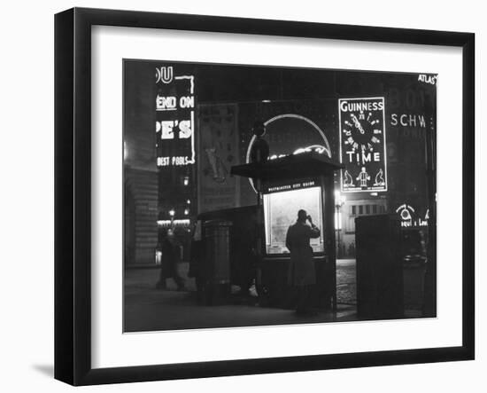 Man in a Raincoat Studies the Westminster City Guide Map at Night in Piccadilly Circus-null-Framed Photographic Print