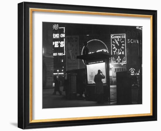 Man in a Raincoat Studies the Westminster City Guide Map at Night in Piccadilly Circus-null-Framed Photographic Print