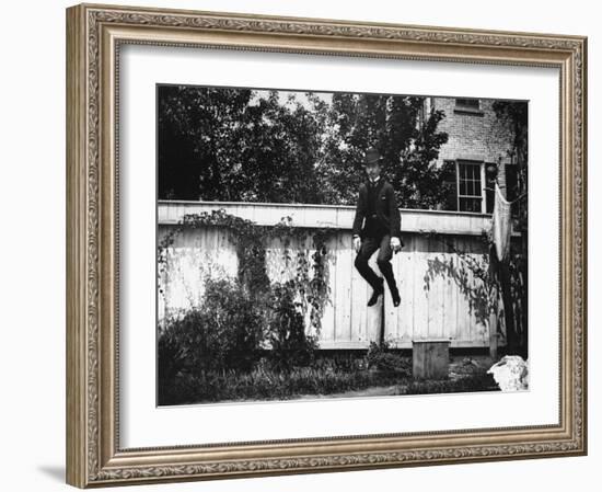 Man in a Suit and Bowler Hat Jumping in the Air in a Backyard in Brooklyn, Ny-Wallace G^ Levison-Framed Photographic Print