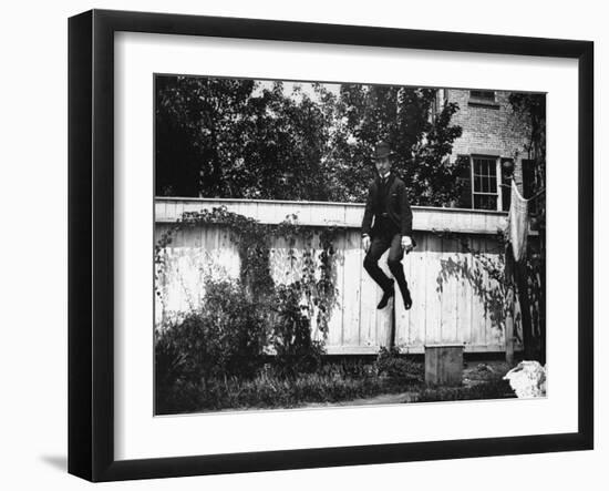 Man in a Suit and Bowler Hat Jumping in the Air in a Backyard in Brooklyn, Ny-Wallace G^ Levison-Framed Photographic Print