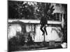 Man in a Suit and Bowler Hat Jumping in the Air in a Backyard in Brooklyn, Ny-Wallace G^ Levison-Mounted Photographic Print