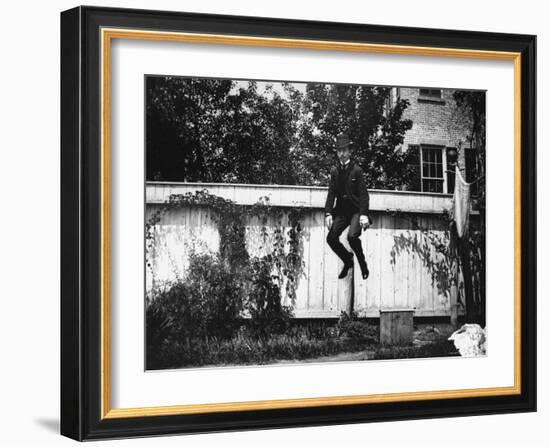 Man in a Suit and Bowler Hat Jumping in the Air in a Backyard in Brooklyn, Ny-Wallace G^ Levison-Framed Photographic Print