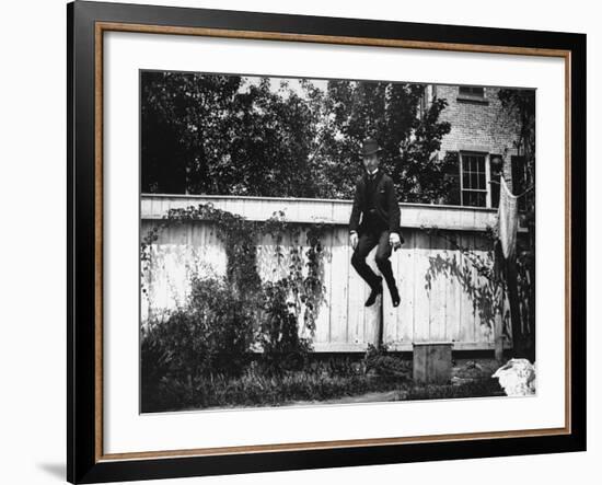 Man in a Suit and Bowler Hat Jumping in the Air in a Backyard in Brooklyn, Ny-Wallace G^ Levison-Framed Photographic Print