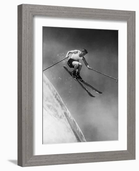 Man in a Vest in Mid-Air as He Skis Down a Steep Mountain-null-Framed Photographic Print
