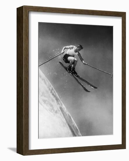 Man in a Vest in Mid-Air as He Skis Down a Steep Mountain-null-Framed Photographic Print