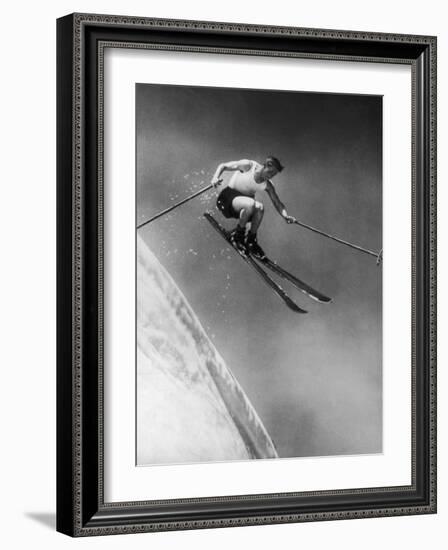 Man in a Vest in Mid-Air as He Skis Down a Steep Mountain-null-Framed Photographic Print