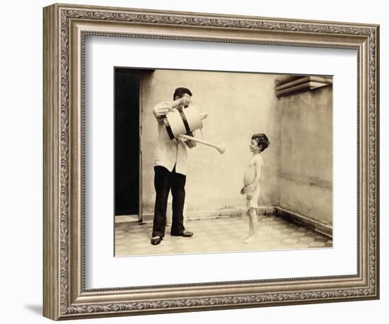 Man Is Sprinkling Boy with Water from Watering Can, 20th Century-Andrew Pitcairn-knowles-Framed Giclee Print
